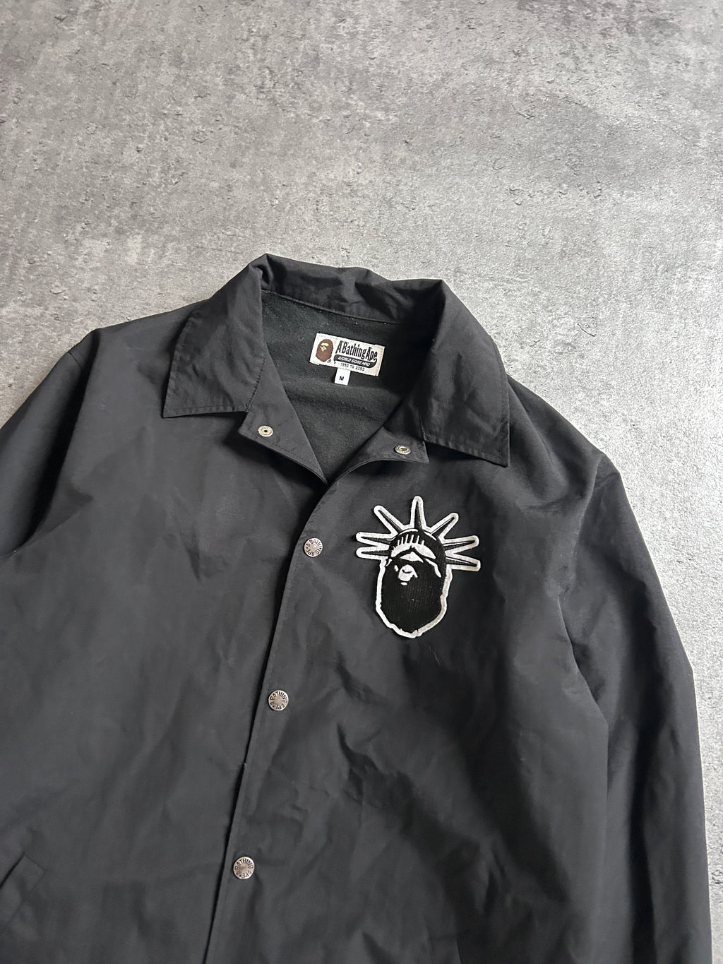 A BATHING APE STATUE OF LIBERTY COACH JACKET (M)
